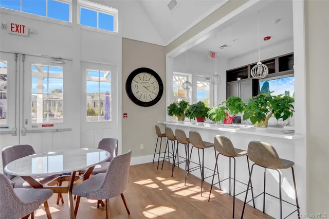 a view of a patio with couches table and chairs and potted plants