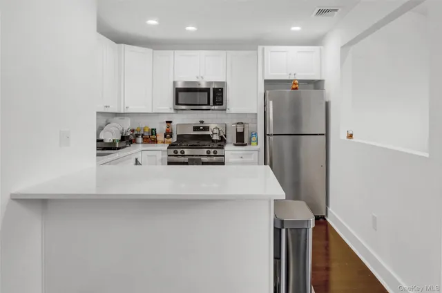 a kitchen with stainless steel appliances a refrigerator stove microwave and sink