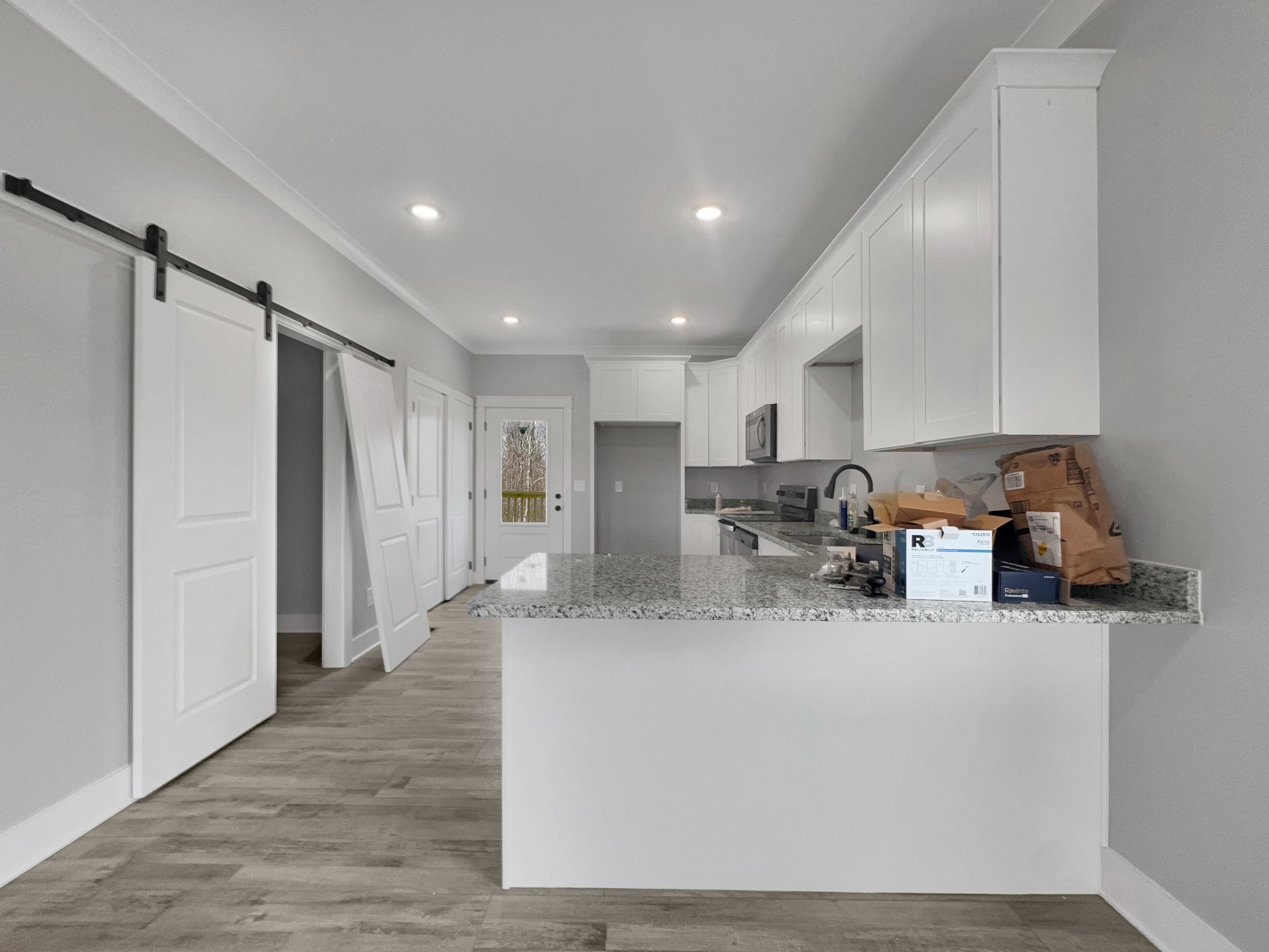 181 Rock House Hollow Road Bethpage, TN 37022 - Photo 14 of 50 a kitchen with stainless steel appliances granite countertop a refrigerator sink and white cabinets