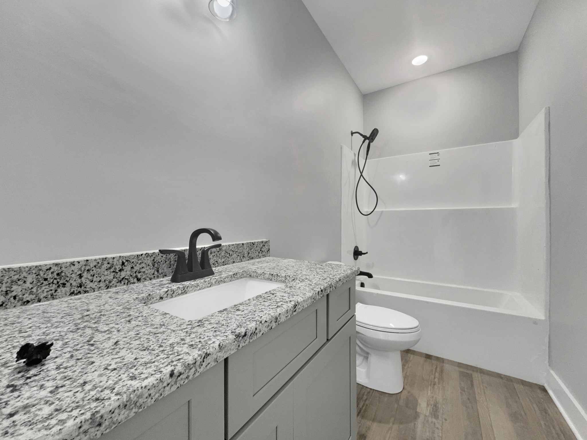 181 Rock House Hollow Road Bethpage, TN 37022 - Photo 28 of 50 a bathroom with a granite countertop sink a toilet and shower