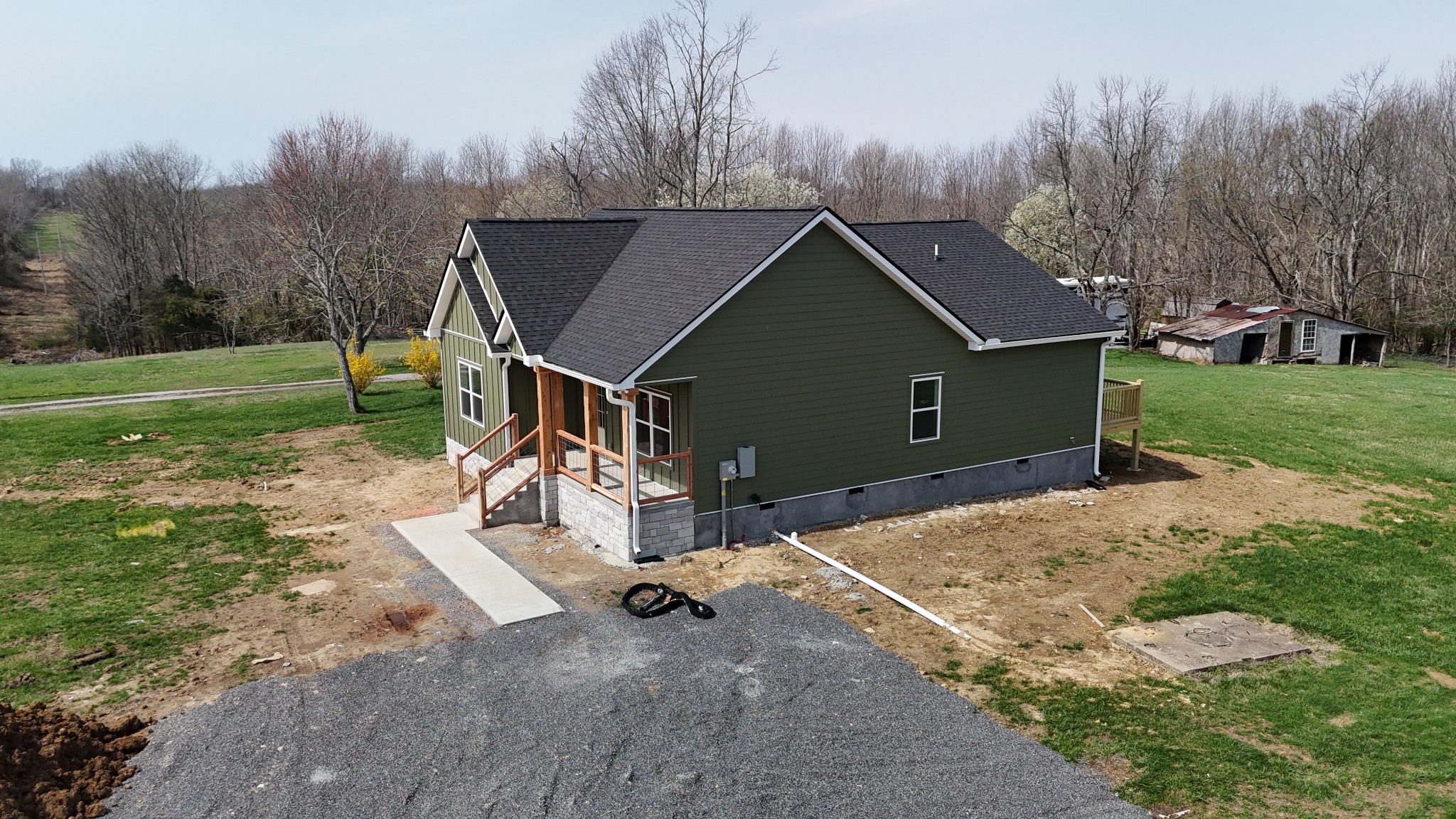 181 Rock House Hollow Road Bethpage, TN 37022 - Photo 33 of 50 a backyard of a house with wooden fence and large trees