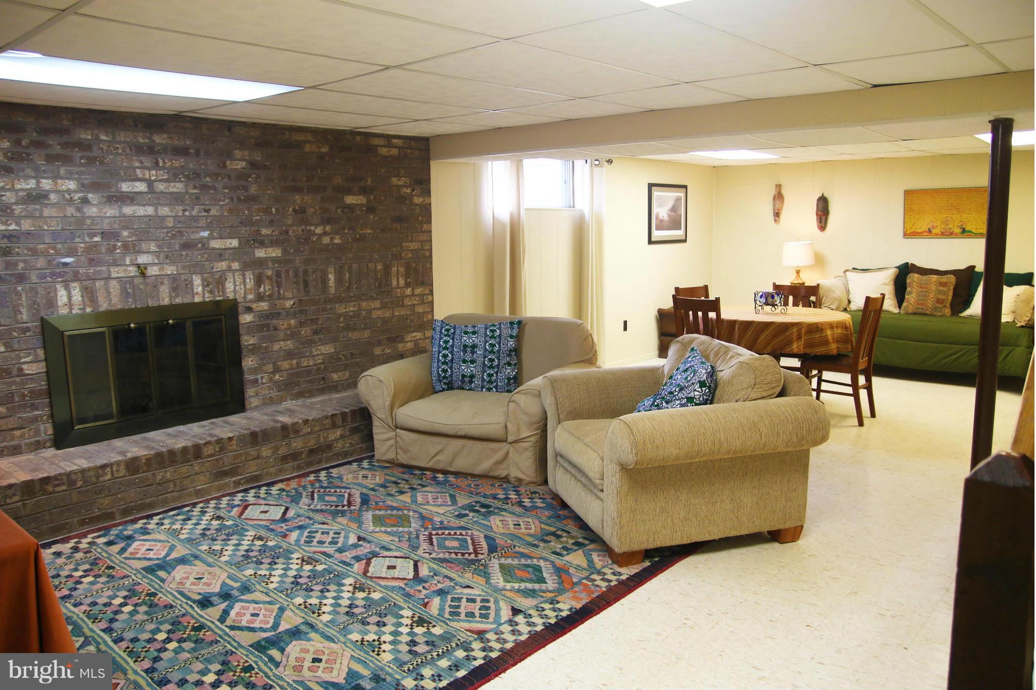 4019 Starbrook Road Randallstown, MD 21133 - Photo 18 of 28 a living room with furniture and a fireplace