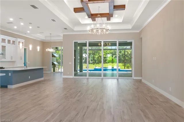 a kitchen with kitchen island granite countertop a sink cabinets and stainless steel appliances
