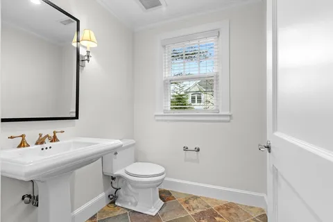 a bathroom with a granite countertop toilet a sink and a bathtub