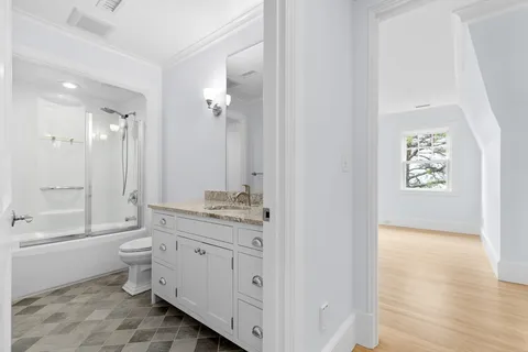 a bathroom with a window and a shower