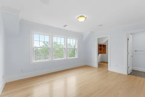 a bathroom with a granite countertop toilet a mirror a vanity a sink and a window