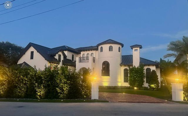 a view of a house with a yard and garage