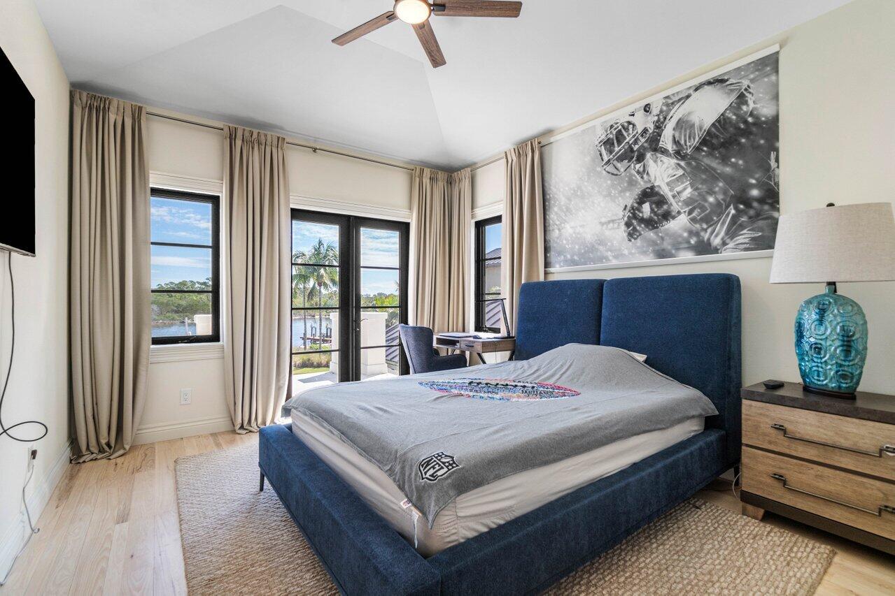 14140 Paradise Point Road Palm Beach Gardens, FL 33410 - Photo 25 of 148 a bedroom with a large bed and a window