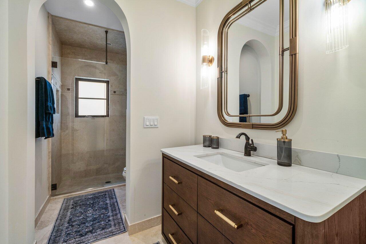14140 Paradise Point Road Palm Beach Gardens, FL 33410 - Photo 33 of 148 a bathroom with a sink a light fixture and a mirror