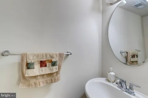 a bathroom with a sink toilet and a mirror