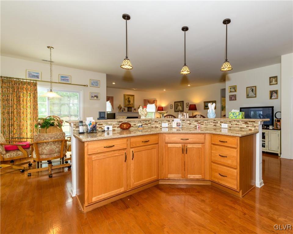 1023 Resolution Drive Bethlehem, PA 18017 - Photo 11 of 26 a kitchen with stainless steel appliances granite countertop a sink a stove and a wooden floor