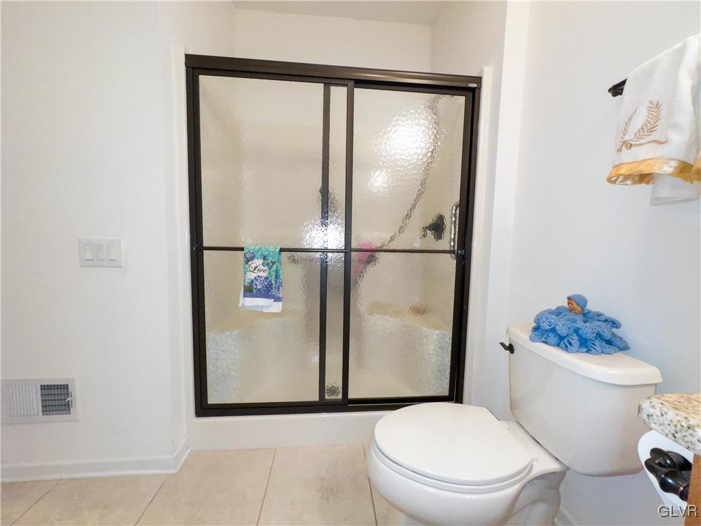 1023 Resolution Drive Bethlehem, PA 18017 - Photo 21 of 26 a white toilet sitting next to a bathroom sink