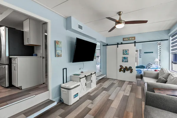 a view of a bedroom with wooden floor and balcony