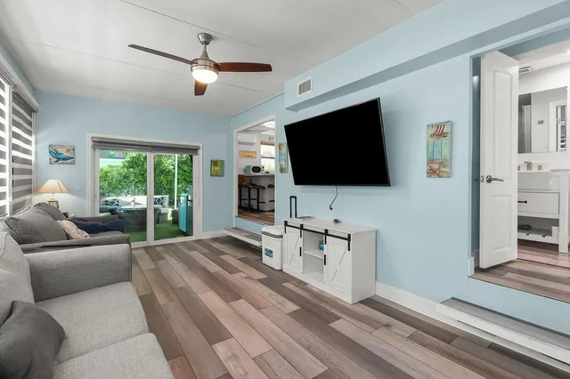 a view of a roof deck with table and chairs under an umbrella