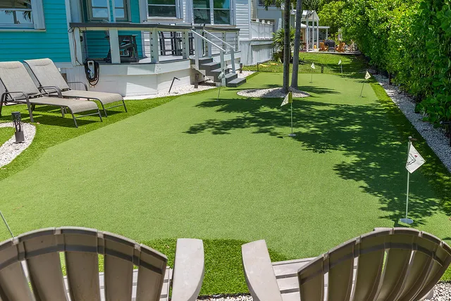 a view of a house with backyard sitting area and garden