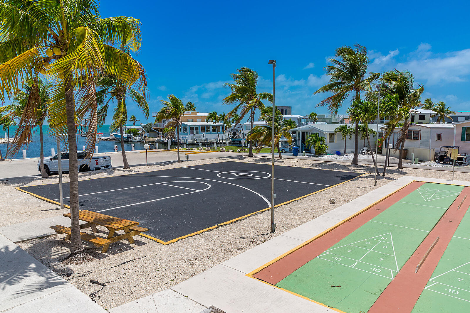 65821 Overseas Highway, Unit 35 Long Key, FL 33001 - Photo 53 of 82 a view of a swimming pool with a lawn chairs under palm trees