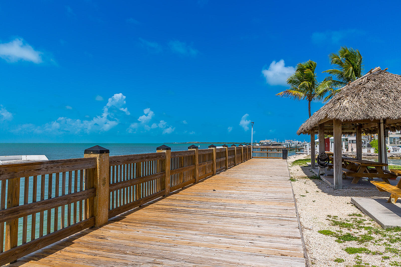 65821 Overseas Highway, Unit 35 Long Key, FL 33001 - Photo 65 of 82 a view of a balcony with wooden floor and outdoor seating