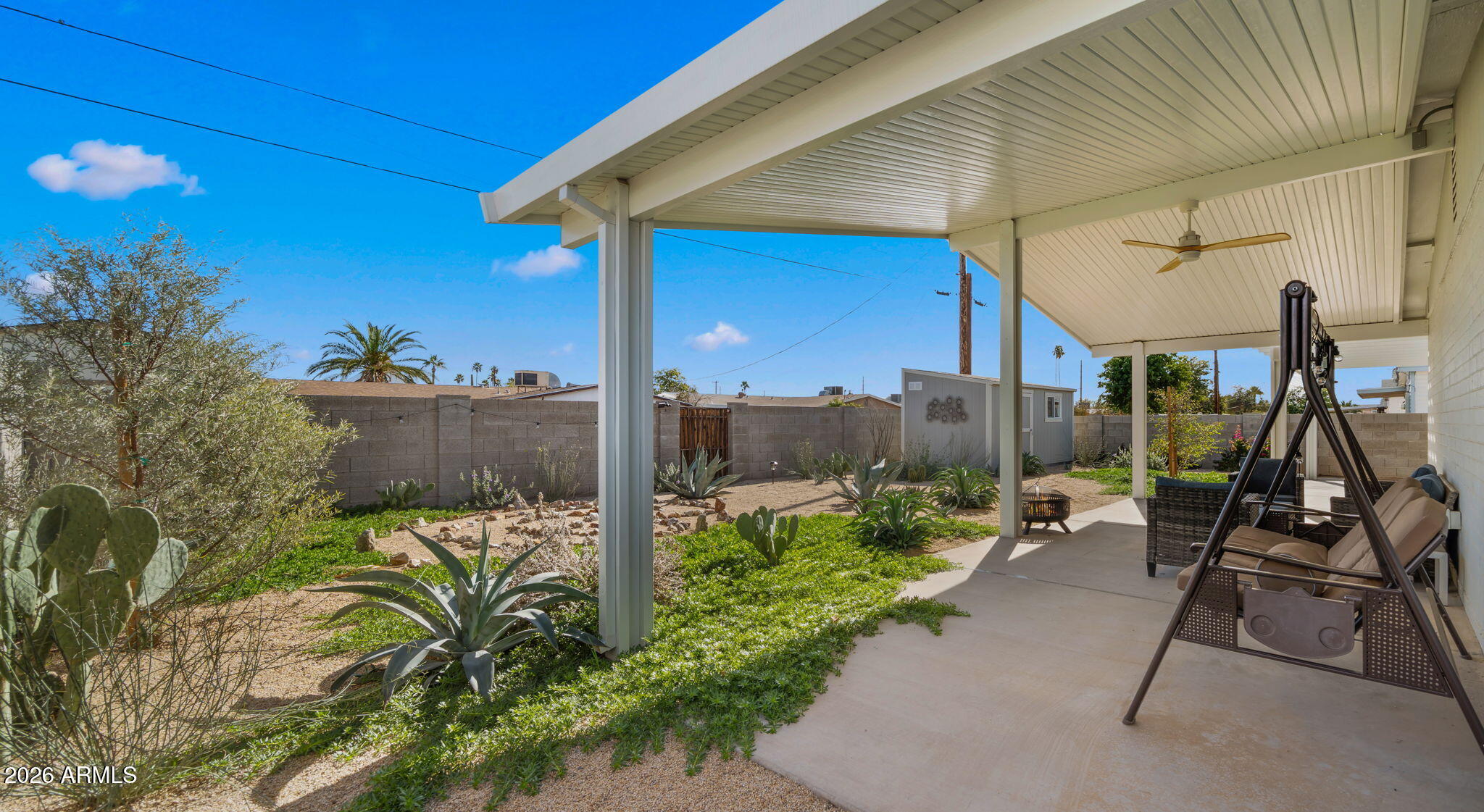 2115 North Normal Avenue Tempe, AZ 85288 - Photo 31 of 38 a view of a patio with table and chairs potted plants with wooden fence
