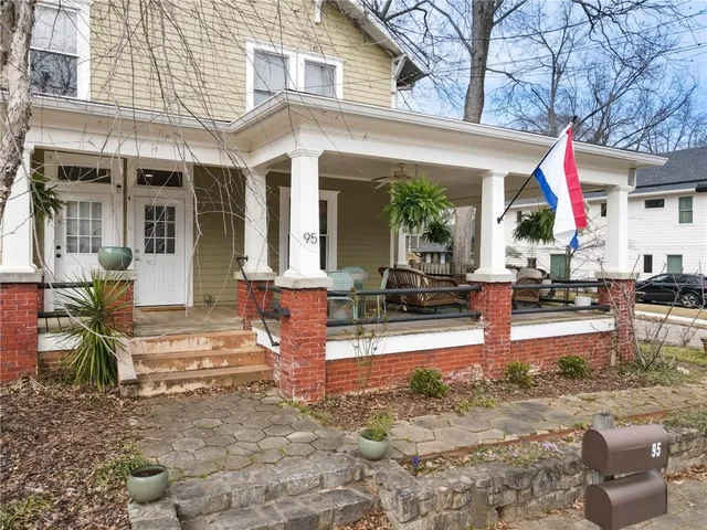 a view of a house with backyard and sitting area
