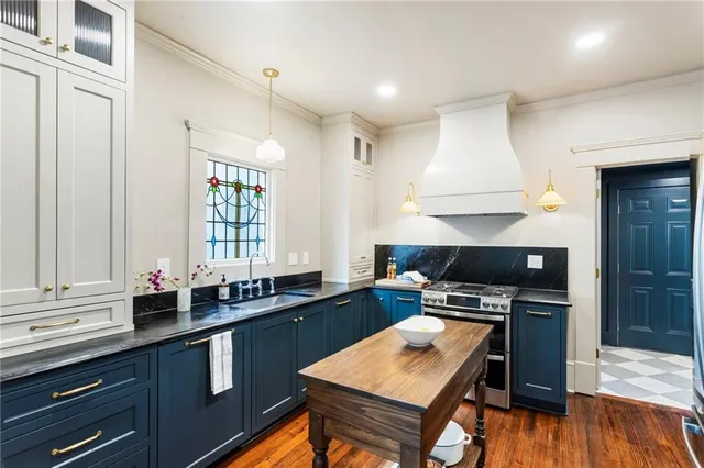 a kitchen with a stove a sink and a refrigerator