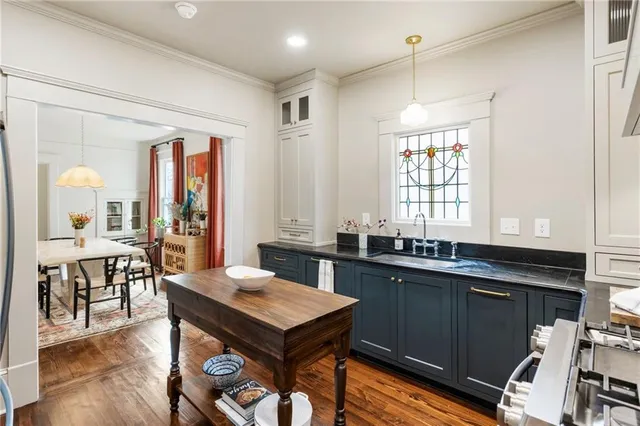 a kitchen with a table chairs sink and cabinets