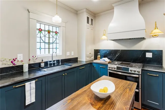 a kitchen with a sink a stove and cabinets