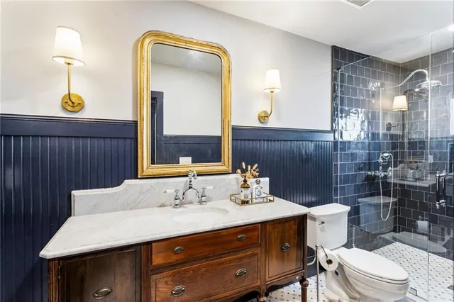 a bathroom with a sink a toilet and shower