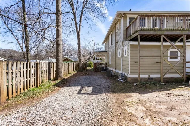 a view of a patio with table and chairs and wooden fence