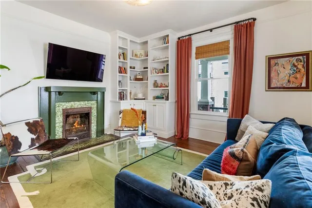 a living room with furniture and a fireplace