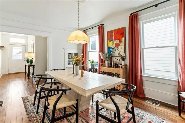 a view of a dining room with furniture window and wooden floor