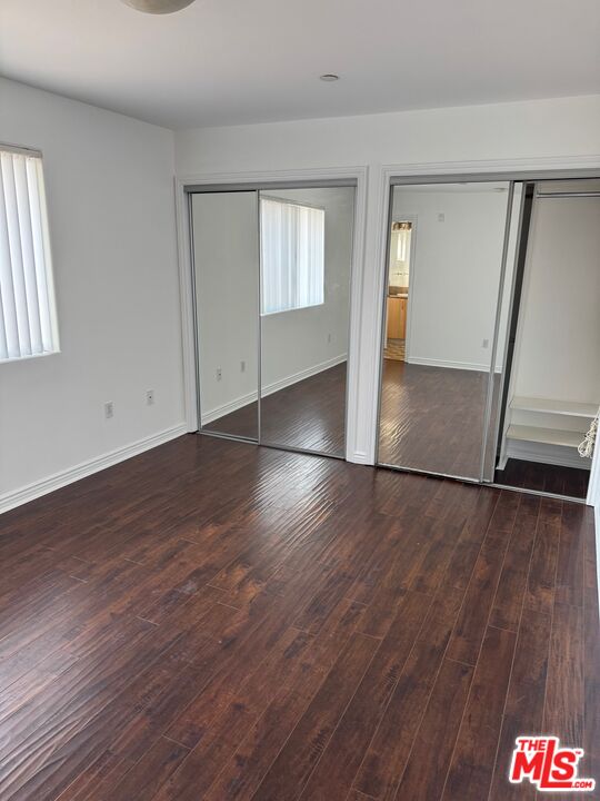 1312 Quintero Street, Unit 11 Los Angeles, CA 90026 - Photo 11 of 16 an empty room with wooden floor and staircase