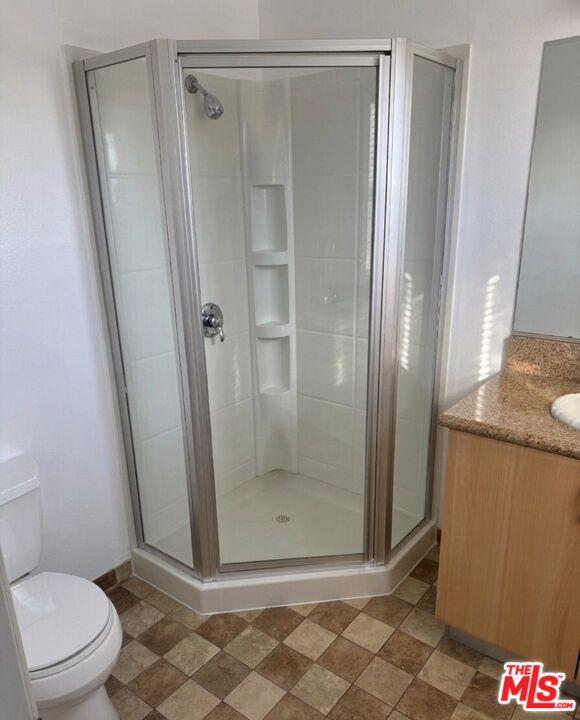 1312 Quintero Street, Unit 11 Los Angeles, CA 90026 - Photo 12 of 16 a bathroom with a granite countertop shower and a toilet