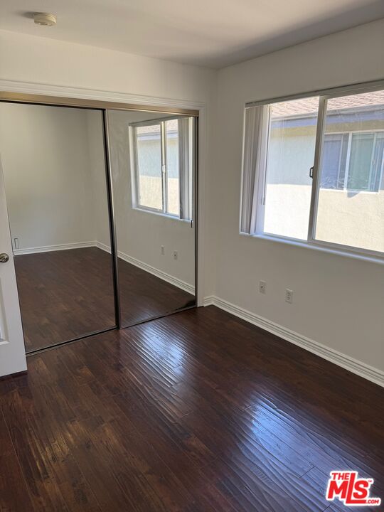 1312 Quintero Street, Unit 11 Los Angeles, CA 90026 - Photo 14 of 16 an empty room with wooden floor and windows