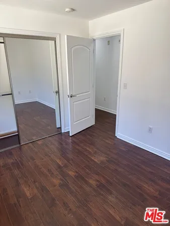 an empty room with wooden floor