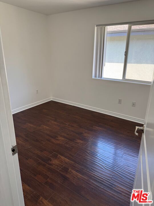 1312 Quintero Street, Unit 11 Los Angeles, CA 90026 - Photo 16 of 16 an empty room with wooden floor and windows