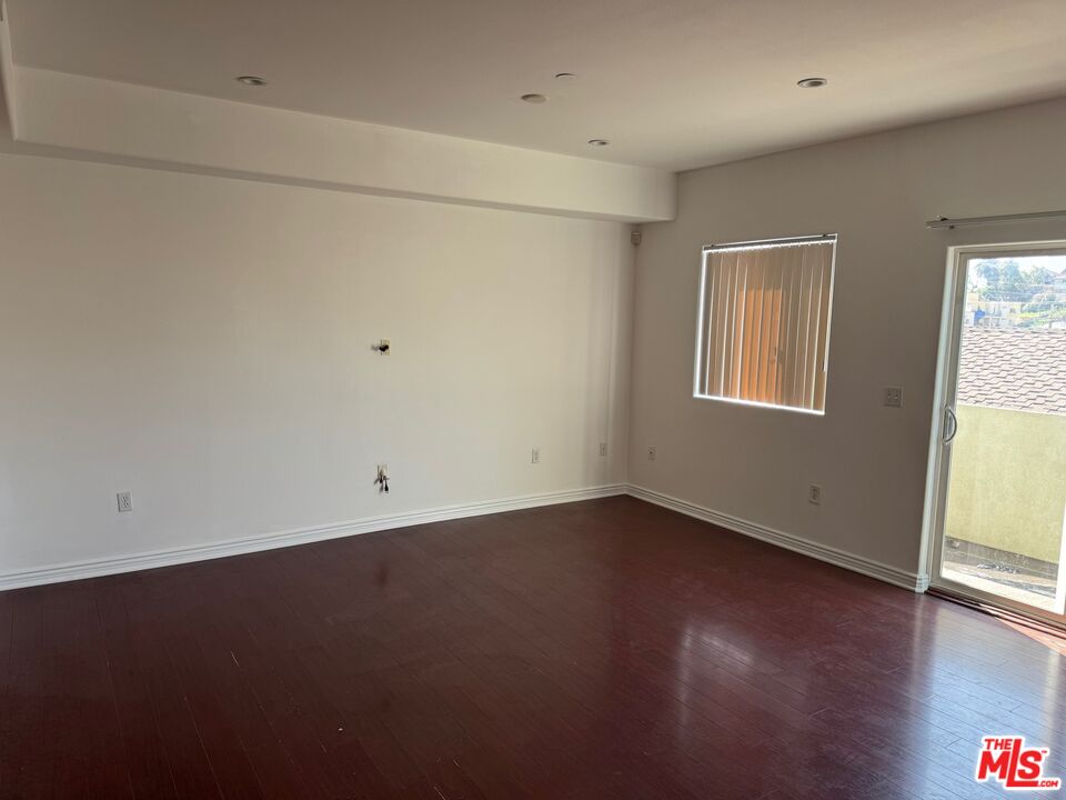 1312 Quintero Street, Unit 11 Los Angeles, CA 90026 - Photo 4 of 16 an empty room with wooden floor and windows