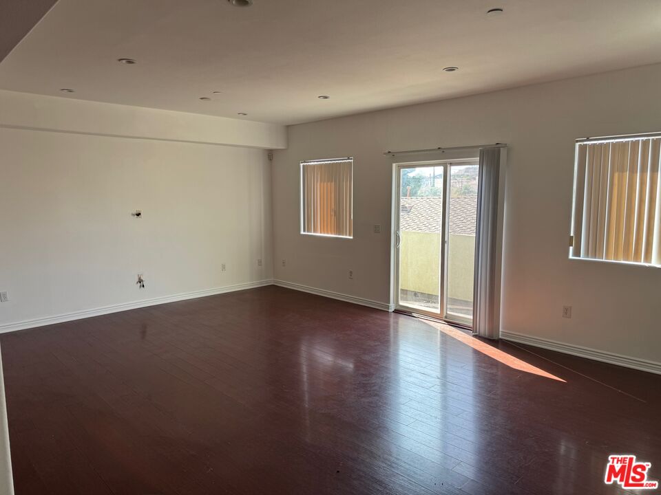 1312 Quintero Street, Unit 11 Los Angeles, CA 90026 - Photo 5 of 16 an empty room with wooden floor and windows