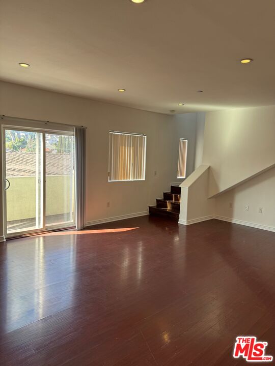 1312 Quintero Street, Unit 11 Los Angeles, CA 90026 - Photo 6 of 16 an empty room with wooden floor and windows