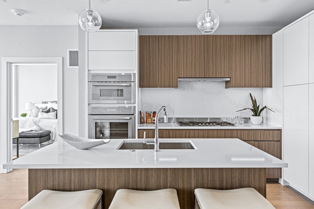 a kitchen with a table chairs sink and cabinets