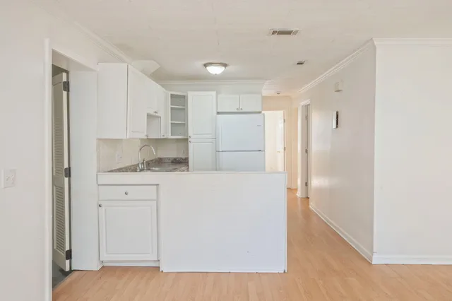 a bathroom with a granite countertop sink mirror and shower