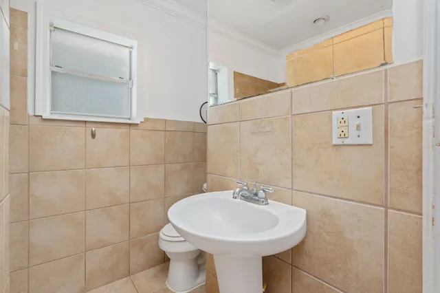 a bathroom with a sink a toilet and mirror