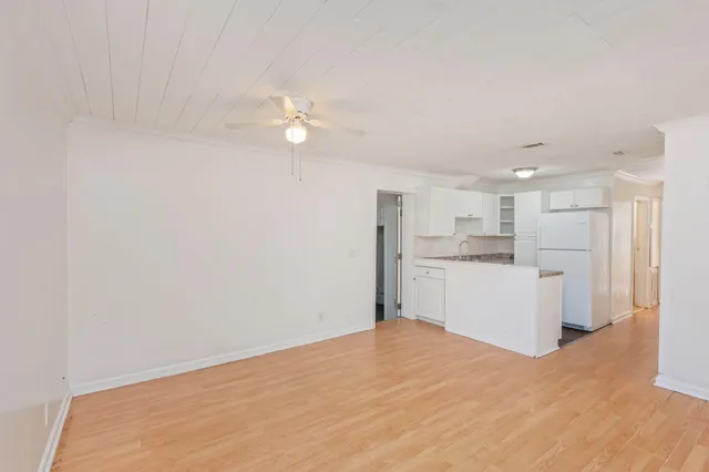 a view of a kitchen with a sink and a refrigerator
