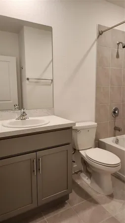 a bathroom with a sink toilet vanity and shower