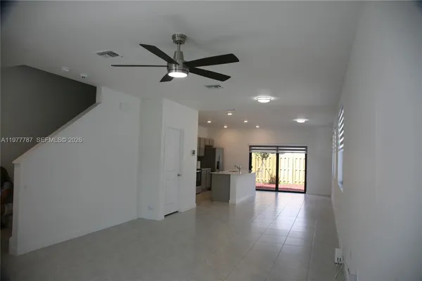 a view of a livingroom with a ceiling fan and window