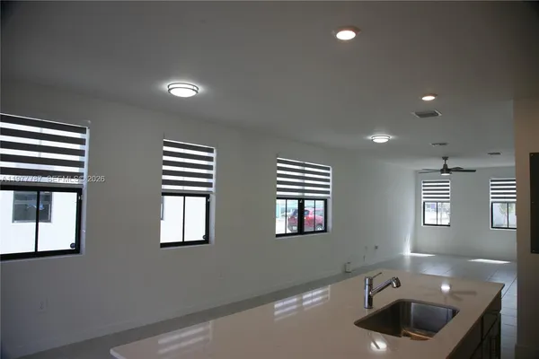 a bathroom with double vanity and windows