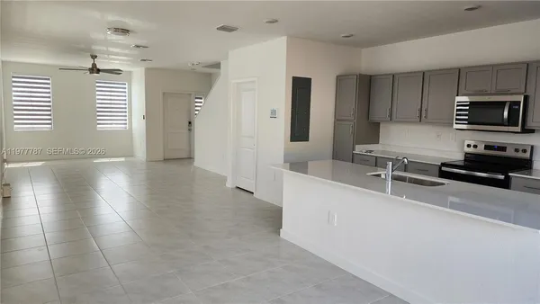 a kitchen with stainless steel appliances a refrigerator and a stove top oven