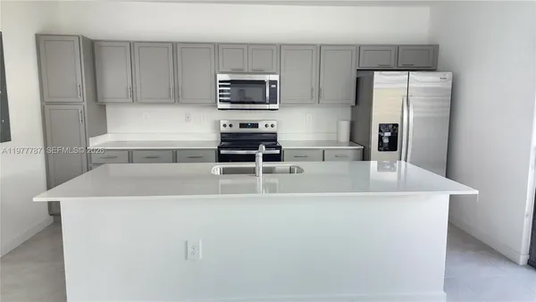 a kitchen with stainless steel appliances a refrigerator and a stove