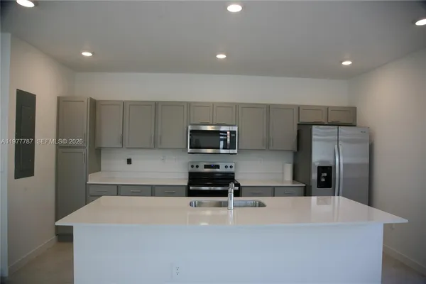 a kitchen with stainless steel appliances a refrigerator and a stove