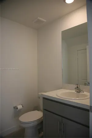 a bathroom with a sink a toilet and mirror