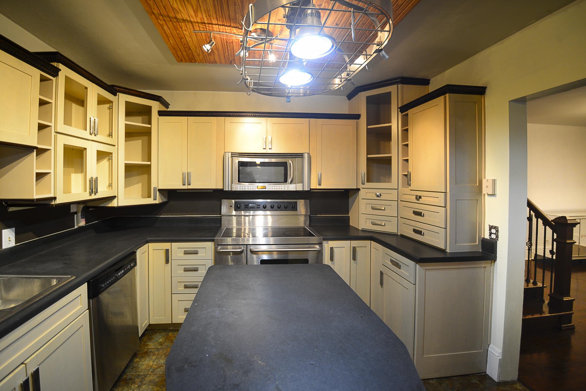 3472 Graves Road Memphis, TN 38116 - Photo 14 of 25 a kitchen with stainless steel appliances a stove sink and cabinets